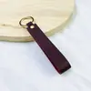 Llavero de PU de color sólido transfronterizo creativo de color caramelo banda ancha de cuero cuerda para la mano simple para llaves de coche de hombre venta al por mayor