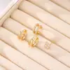 Brincos de Clipe Argola Dupla Vazada Minimalista Transfronteiriços Europeus e Americanos com Trevo de Quatro Folhas Cravejado de Diamantes, Design Elegante e Compacto