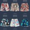 Bermudas de Playa Hawaianas para Hombre Verano Orilla del Mar Pantalones Cortos con Flores Vacaciones en la Playa Combinación Versátil Moda para Parejas Pantalones Cortos de Secado Rápido