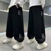 Calça Jogger Masculina Primavera e Outono 2026 Novo Estilo Calças Infantis Estilosas e Descoladas Calças Longas Estilo Esportivo para Meninos Calça de Moletom Casual Solta