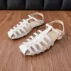 Sandalias Romanas Nuevas de Primavera 2026 para Mujer con Punta Abierta, Suela Plana Tejida Hueca, Hebilla de Correa Única, Zapatos Versátiles y Cómodos para Mujer al por Mayor
