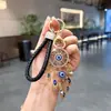 Llavero Atrapasueños Ojo Turco con Diamantes Incrustados de Aleación, Colgante de Pluma, Cordón de Cuero Tejido, Accesorio para Bolso de Mujer