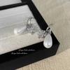 Pendientes de circonita con forma de flor de cuatro hojas y explosiones transfronterizas, pendientes de perlas barrocas, pendientes de alta gama con temperamento de moda.