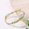 Pulsera de cuerda de mano con nudo de hoyuelos tejida a mano con colgante de cuenta de transferencia dorada ponible para hombres y mujeres moda nacional nudo de flor de durazno