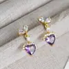 Pendientes de Cobre Dorado con Circonitas en Forma de Corazón Brillantes Blancos y Morados para Mujer 2026 Nuevo Estilo Pendientes de Alta Gama Pendientes Únicos y Hermosos