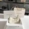 Una generación de bolso pequeño de axila tipo medialuna color crema 2025 primavera bolso de hombro baguette de alto diseño al por mayor