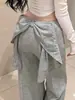 Pantalones casuales de pierna ancha estilo retro americano 2026 con detalle de lazo en la espalda, cintura elástica y diseño hasta el suelo, presentando un look único y elegante