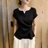 Elegante top negro de estilo francés con diseño hueco y encaje de retazos, con cordones para ceñir la cintura, para mujer, nuevo estilo de verano 2026, estilo commuter, manga corta