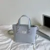 Bolsa pequena feminina 2026 novo modelo primavera-verão, textura de alta qualidade, design de nicho, bolsa transversal versátil vintage, bolsa de mão tipo balde