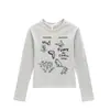 Camiseta branca de gola redonda, ombro normal, manga longa para mulheres, novo estilo primavera e outono, estampa divertida de desenho animado estilo americano, modelagem slim, top moderno
