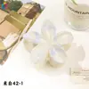 Nuevo Clip de Huevo con Flores Qiyue Moda Impresión UV Pasador de Orquídea Florale Clip de Tiburón Creativo Europeo y Americano