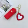 Venda Direta da Fábrica Bolsa de Batom Portátil Fashion com Espelho em Formato de Coração, Estojo de Couro Protetor para Batom, Chaveiro com Pingente, Porta-Batom