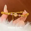 Pulseira wrap estilo loja de ouro 2026, cor ouro de areia com ametista para mulheres, luxuosa joia de pulso em camadas com nove camadas de fogo roxo escovado