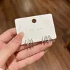 Aretes de botón con cuatro garras incrustados de diamantes diseño de nicho sentido del temperamento aretes de plata estilo nuevo alta gama moda joyería de oreja versátil para mujeres
