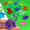 Simulación de dibujos animados pequeño dinosaurio agujero premio accesorios patio de juegos máquina atrapa muñecos joyería acrílica juguete de simulación para niños