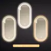 Espejo de baño inteligente ovalado para pared salón de belleza con luz pantalla táctil LED inducción antivaho espejo de tocador HD