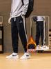 Pantalones deportivos casuales para hombre holgados talla grande Primavera y Otoño 2024 Nuevo Combinación de colores a rayas Juventud Casual Pierna Pantalones que combinan con todo