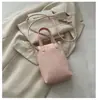 Mini bolso para teléfono móvil con colgante de corazón de lunares de color sólido estilo coreano transfronterizo, bolso de mano de cuero suave, bolso cruzado para niñas