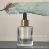 Venta al por mayor del fabricante Botella gotero cilíndrica de fondo grueso con punta de goma Esencia facial Aceite esencial Cosméticos Botella vacía verde transparente