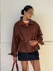 Moda transfronteriza europea y americana, chaqueta casual de color liso estilo Harajuku con cuello alto para mujer, con cintura de cordón y diseño de bolsillo, al por mayor