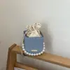 Bolsa de Hilo de Diseño Único 2026 para Mujer, Nueva de Moda con Cadena de Perlas Texturizada Elegante Bolso Cubo de Hombro Cruzado