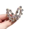Pinza para el pelo ovalada hueca de cristal versión coreana 2026, lujo ligero y elegante, pinza lateral para mechones sueltos, diseño de nicho, accesorio popular para el pelo en línea