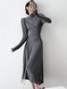 Otoño e invierno Nuevo vestido largo de punto para mujer Diseño francés temperamento irregular adelgazante vestido básico con Abrigo
