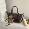 Bolso tote pequeño retro de alta gama para mujer 2026 nuevo bolso de hombro simple versátil bolso cruzado casual tipo dumpling de moda