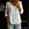 Nueva camisa estampada de cuello V abotonada de manga larga transfronteriza para mujer, elegante y con estilo para ir al trabajo, top casual único y moderno
