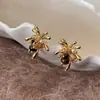 Pendientes de ojo de tigre Maillard con diseño de fuegos artificiales dorados para otoño e invierno para mujer 2026 nuevos pendientes vintage de lujo ligero de alta gama