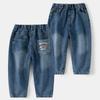 Jeans de niño 2025 Primavera y Otoño Pantalones nuevos para niños Jeans de color puro con dibujos animados para bebé para ropa exterior