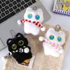 Lindo gato blanco y negro de ojos grandes sosteniendo un pequeño pez de peluche llavero colgante para mochila venta al por mayor