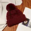 Gorro de punto rojo para mujer 2026 nuevo estilo viaje Sichuan-Tíbet protección cálida para los oídos gorro de punto circunferencia de cabeza grande punto trenzado pompón gorro para el frío