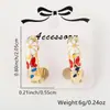 Aretes de anillo de flor gota de aceite mariposa con baño de oro de 18k diseño de nicho aretes transfronterizos europeos y americanos para mujer al por mayor