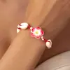 Directo de fábrica moda pequeña fresca flor de arcilla blanda concha pulsera tejida femenina joker cuerda de mano tejida a mano venta al por mayor