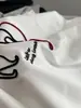 La textura es no más que diseño tridimensional cepillo de dientes bordado línea roja cuerda cachorro manga corta cuello redondo estilo casual camiseta 90% algodón damas