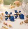 Comercio exterior transfronterizo estilo metálico esmalte de gota creativo irregular forma de flor multicolor fluido esmalte colorido aretes stud pendientes