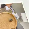 Moda guirlanda redonda vazada trevo de quatro folhas metal botão de perna alta camisa cardigã terno casaco top fivela decorativa