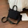 Otoño 2026 Nuevo Bolso Cuadrado Pequeño Color Sólido Casual Japonés Bolso de Mano con Personalidad Elegante Bolsita para Teléfono para el Trabajo y el Trayecto Bolso de Moda
