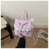 Bolsa de mão de nicho transfronteiriça para estudantes, nova mochila fofa simples de moda com laço primavera/verão 2026