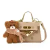 Bolso de lunares estilo coreano para niñas pequeñas, con un adorable charm de oso de peluche, un nuevo minibolso cruzado para bebés y niños