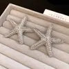 Pendientes de estrella plisados con aguja de plata estilo vacacional, nuevos pendientes retro europeos y americanos 2026, lujo ligero con una sensación de alta gama y elegancia
