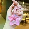 Llavero de Concha de Arena Movediza Oceánica Rellenado de Aceite Acrílico al por Mayor, Colgante de Mochila de Estrella de Mar Caracola Arena Movediza Regalo al por Mayor