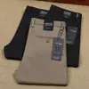 Pantalones casuales lisos de algodón elástico de fibra de poliéster grueso para otoño e invierno, de color sólido, para hombre, de oficina, de negocios, brillantes