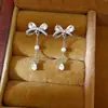 Pendientes de perla con lazo de circón y aguja de plata, elegantes y de moda, versátiles para ir al trabajo, sensación de lujo ligero y alta gama, pendientes al por mayor