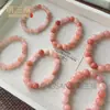 Venta al por mayor del fabricante Pulsera de Flor de Durazno Original de Xinjiang Natural Jade Oro Seda Jade Flor de Durazno Relleno Polvo de Cristal Rosa