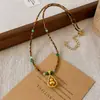 Collar Colgante de Calabaza Dorada Hueca con Zirconia de Arena de Ojo de Tigre Facetado de Partículas Pequeñas Accesorios de Cadena Elegante para Suéter Femenino