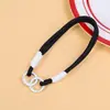 Colgante de juguete de peluche con cordón tejido multicolor, correa de muñeca para teléfono móvil, correa corta de mano con doble hebilla, accesorio de cordón de nailon