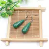 Venta al por mayor de fábrica aretes largos de cristal natural forma de gota de agua amatista Ojo de Tigre Joyería con gancho para la oreja aretes redondos de gota de agua DIY