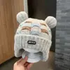 Bonitos y adorables gorros de otoño e invierno para niños, con diseño de poner, material de punto y una serie de dibujos animados, que brindan abrigo y protección para los oídos para bebés y niños pequeños.